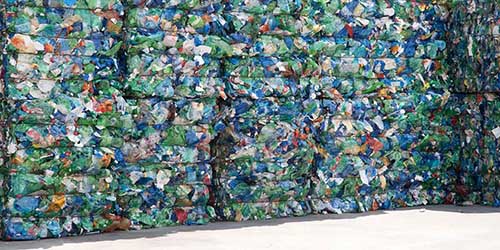 Stacks of Recyclable Materials Waiting at a Recycling Facility.