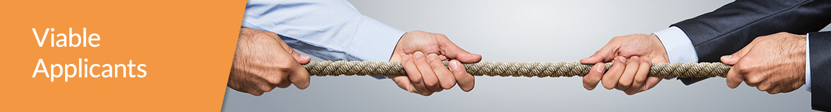 Two businesspersons pulling a rope in a tug of war.