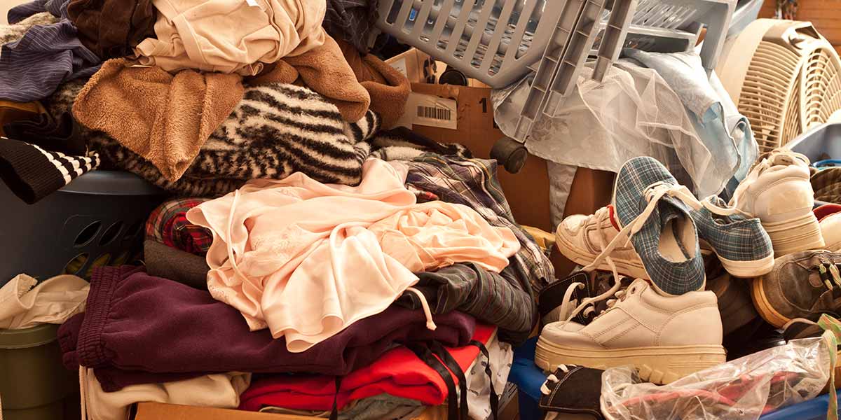 A Pile of Clothes, Shoes, Baskets and Boxes.