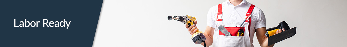 Construction worker with no helmet on holding multiple tools and looking like they don’t know how to use them.