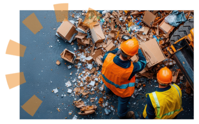 Two construction workers in orange hard hats and wearing safety vests standing in a pile of general jobsite waste.