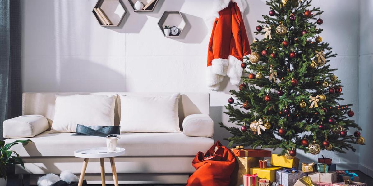 White Room With Minimalist Furniture and a Christmas Tree With Presents