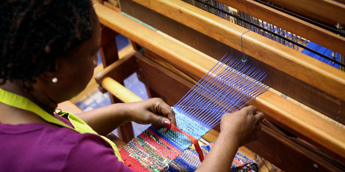 re:loom weaver at her station.