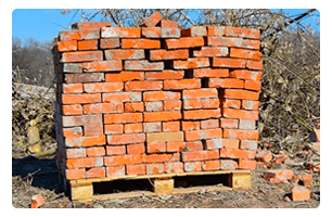 A stack of bricks on a wood pallet.