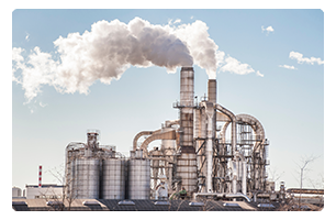 Industrial factory with smoke coming out of the smokestack.