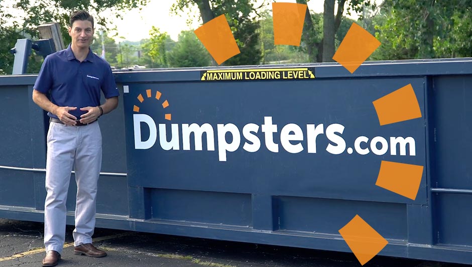 Person Standing in Front of Dumpsters.com Dumpster