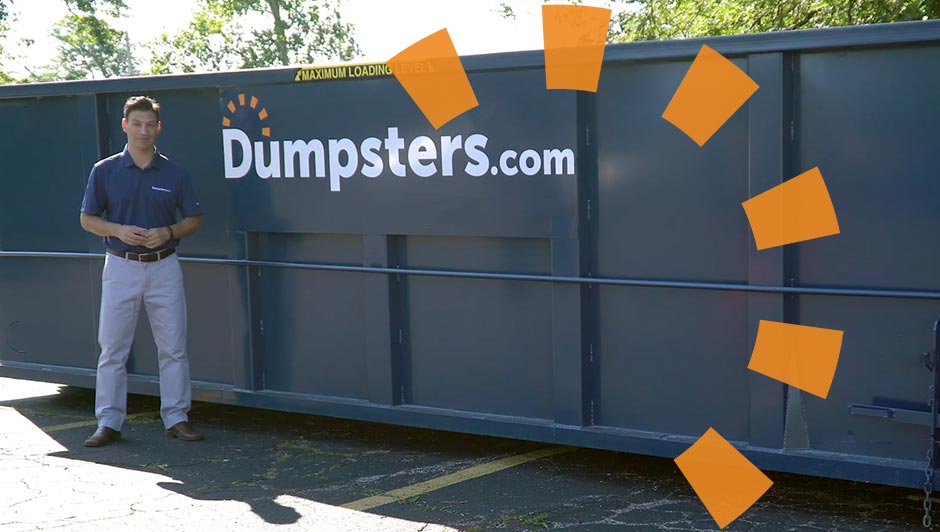 Man Standing in Front of Dumpsters.com Dumpster