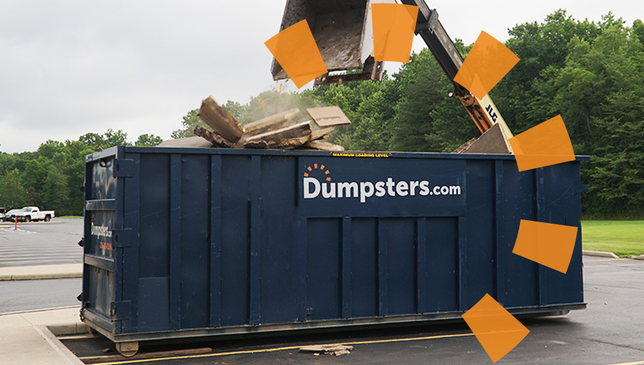 Dumpsters.com dumpster being loaded with debris on a demolition jobsite.