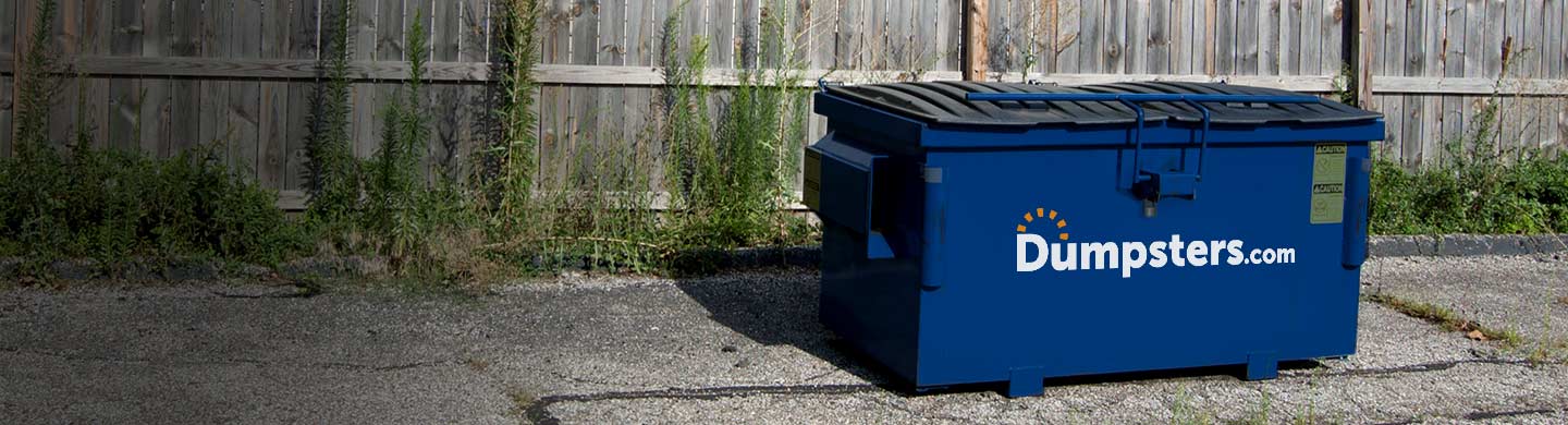 2 cubic yard dumpster in a commercial parking lot