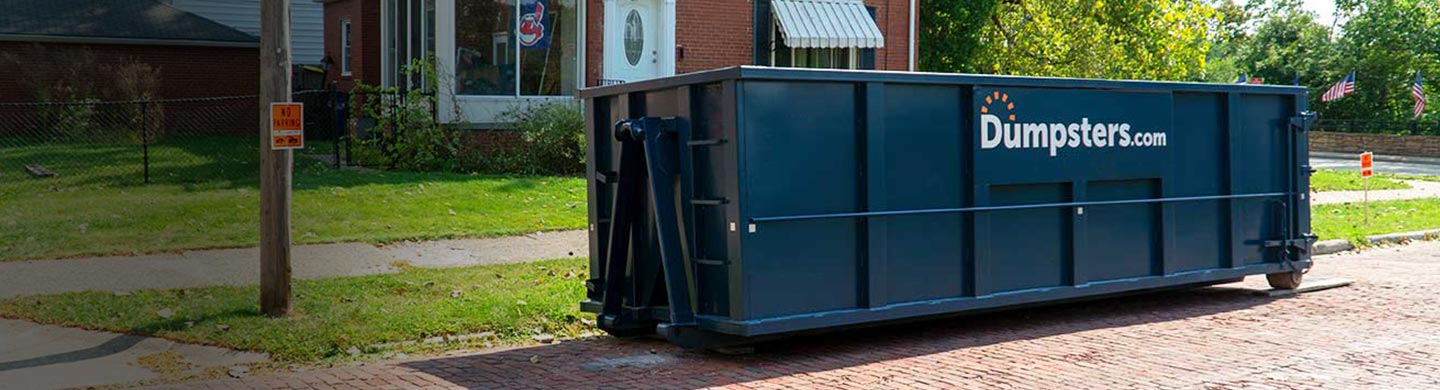 Blue 30 Yard Dumpsters With Dumpsters.com Logo Outside of Home