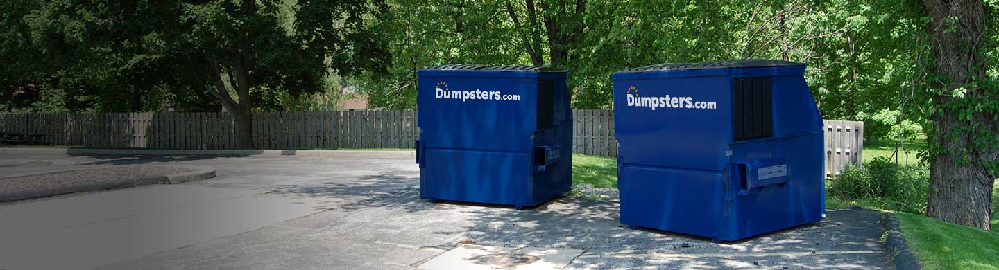 Silhouette of an 8 Cubic Yard Dumpser With a Dumpsters.com Logo Behind a Building