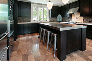 Black cabinetry and stainless steel appliances in a kitchen.