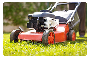 A red lawnmower cutting grass.
