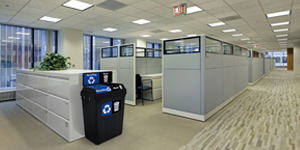 office workers sitting next to stacked boxes