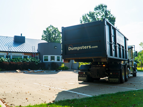 circle image of a roll off dumpster for a roofing project