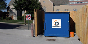 Blue Commercial Dumpster Inside an Enclosure